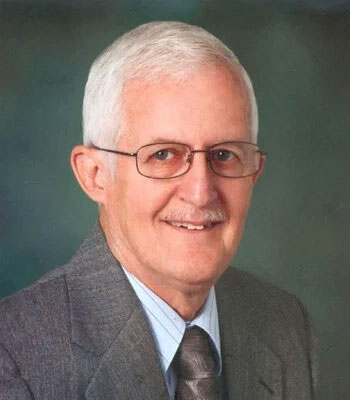 Village of Painted Post Mayor Ralph Foster in a grey suit with a light grey striped shirt and silver tie